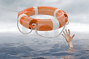 Man is drowning in ocean and is catching life buoy