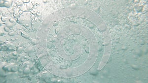 Man drowning in ocean forming air bubbles