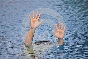 Man drowning in out door swimming pool while swimming alone, raising two hands and asking for help SOS