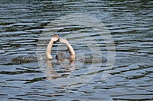 A man drowns in a pond. The man`s hands are sticking out of the water