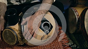 Man drumming out a beat on an arabic percussion drum named Frudu
