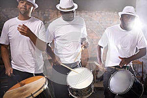 Man, drums and group band playing with instrument at festival, carnival or night party with lens flare. Male person