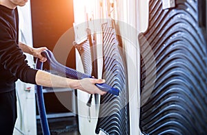 Man drying car carpet with vacuum cleaner after washing