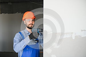 man drywall worker installing plasterboard sheet to wall