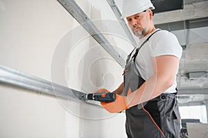 man drywall worker installing plasterboard sheet to wall