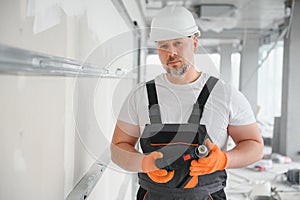 man drywall worker installing plasterboard sheet to wall