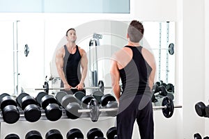 Man with dumbbell weight training equipment gym