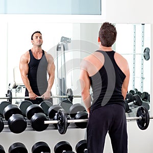Man with dumbbell weight training equipment gym