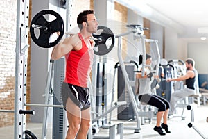 Man with dumbbell weight training equipment gym