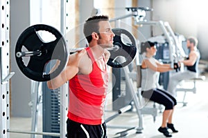 Man with dumbbell weight training equipment gym