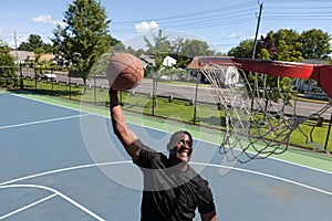 Man Dunking a Basketball