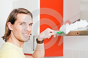 Man dusting his apartment