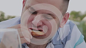 A man eagerly eats junk food in a restaurant.