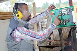 Man with ear protection working in factory