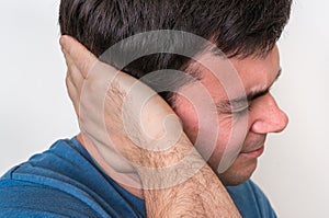 Man with earache is holding his aching ear