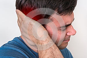 Man with earache is holding his aching ear photo