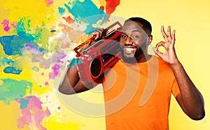 Man ears the music with an old stereo and dances. emotional and energetic expression. yellow background