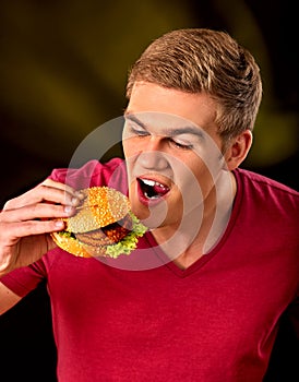 Man eat hamburger. Fastfood and junk food concept.