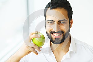 Man Eating Apple. Beautiful Girl With White Teeth Biting Apple.