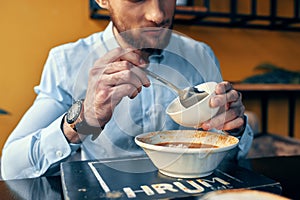 Man eating borscht and pilaf cafe restaurant interior business finance shirt model