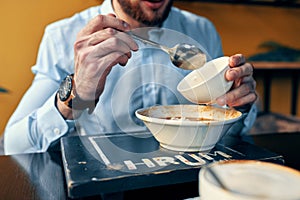 Man eating borscht and pilaf cafe restaurant interior business finance shirt model