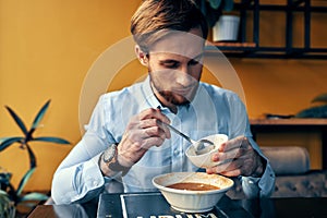 Man eating borscht and pilaf cafe restaurant interior business finance shirt model