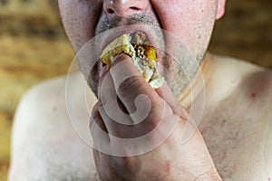 Man eating Burger. Topless man eating burger