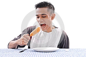 Man Eating A Corn Dog