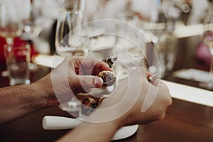 Man eating escargots with special fork while enjoying dinner in restaurant during vacation