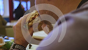 Man eating fast food close-up, Burger and fries.