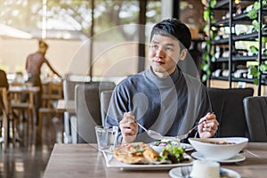 Man eating with food in restaurant