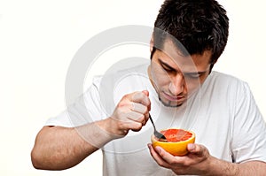 Man eating grapefruit