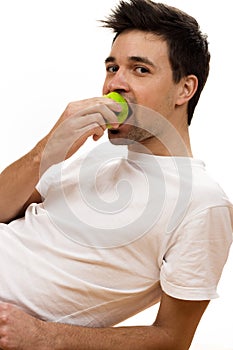 Man eating green apple