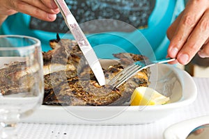 Man eating grilled fish