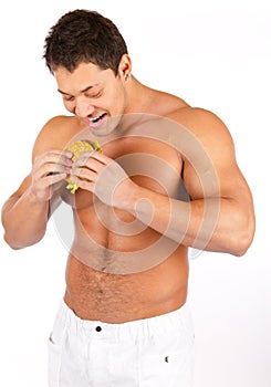 Man eating hamburger over white