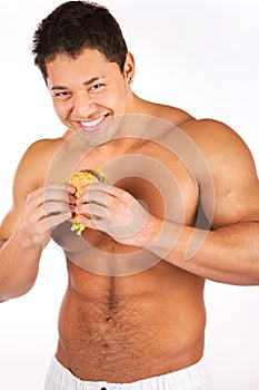 Man eating hamburger over white