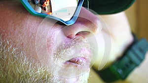 Man eating ice cream. Close-up portrait of young hipster man in sunglases eating ice cream in summer hot weather on the