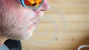 Man eating ice cream. Outdoor closeup portrait of young hipster man in sunglases eating ice cream in summer hot weather