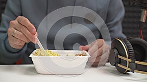 man eating instant noodles