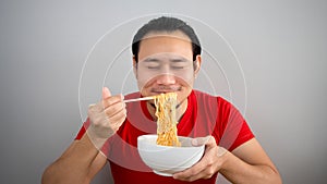 Man eating instant noodles.