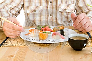 Man Eating an Japanese Food . photo