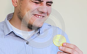 Man eating lemon. Laugh from sour taste