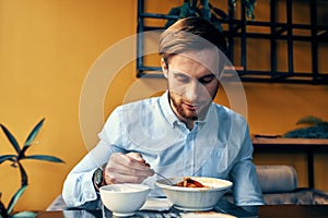 man eating lunch at cafe table break at work and interior