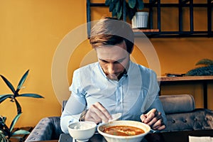 man eating lunch at cafe table break at work and interior