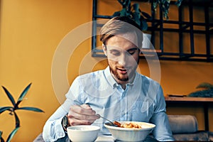 man eating lunch at cafe table break at work and interior