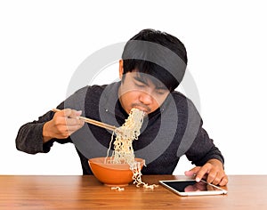 Man eating noodle and using tablet isolate