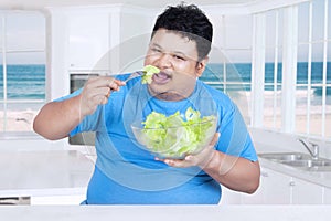 Man eating organic salad at home