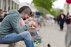 Man eating outdoors on food festival in Ljubljana, Slovenia.