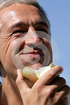 Man eating pear photo