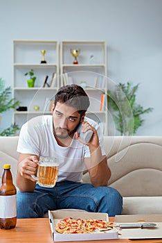 The man eating pizza having a takeaway at home relaxing resting